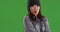 Joyful young woman feeling cold on greenscreen