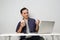 joyfull happy asian man at workplace while sitting in front of laptop computer. on isolated background