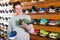 Joyous athlete chooses sporty clothes and comfortable shoes in the sports shop