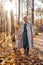 joyous child boy and mother spending time together walking in park in warm autumn season