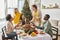 joyous family members sitting at Christmas
