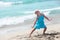 Joyous girl posing on sandy beach