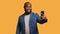 Joyous man using smartphone to take selfies, studio background