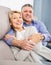 joyous mature married couple in house are warmly reconciled after quarrel