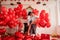 Joyous moment between dancing young couple celebrating with toast Valentines day near red balloons