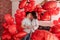 Joyous moment between young couple celebrating with toast Valentines day near red balloons