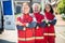 Joyous paramedics in red uniforms ready for their shift