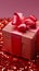 Joyous presentation Festive tinsel accents a vibrant red gift box