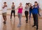 joyous teenage boys and girls learning in dance hall