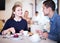 joyous woman with boyfriend meeting and drinking coffee with pastry at cafe