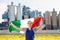 Joyous young woman holds the national flag of Italy
