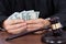 Judge counting banknotes at desk