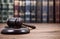 Judge Gavel on a black wooden background in front of law librar