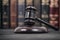 Judge Gavel on a black wooden background in front of a law library.