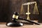 Judge gavel, book and scales on the wooden lawyers desk, justice