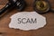 Judge gavel, golden bitcoin and torn paper written with SCAM