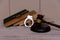 Judge gavel and handcuffs lie beside pile of books on concrete background