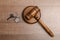 Judge gavel and house key on wooden background. Estate law concept