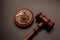 Judge gavel and key chain in shape of two splitted part of house on wooden background. Concept of real estate auction or