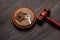 Judge gavel and key chain in shape of two splitted part of house on wooden background. Concept of real estate auction or