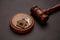 Judge gavel and key chain in shape of two splitted part of house on wooden background. Concept of real estate auction or