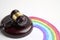 Judge gavel and LGBT rainbow on a white background