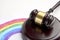 Judge gavel and LGBT rainbow on a white background