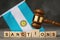 Judge gavel, wooden cubes with the text on the background of the flag, the concept on the topic of sanctions in Argentina