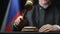 Judge hammering with wooden gavel against Russian flag in court room