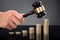 Judge Hands Hitting Gavel On Stacked Coins