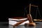 Judge`s gavel, books and scales on table against black background. Criminal law concept