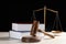 Judge`s gavel, books and scales on white wooden table. Criminal law concept