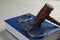 Judge`s gavel, handcuffs and book on wooden background, closeup. Criminal law concept