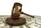 Judge\'s gavel standing on a dollars