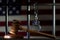 The judge`s wooden hammer on the background of bars, handcuffs, the American flag. Concept: court session, announcement of the ver