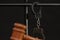 The judge`s wooden hammer for sentencing against the background of bars and handcuffs. Concept: court session, trial, sentencing.