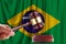 Judge wooden gavel on the background of the flag of Brazil. Oil and gas industry. The concept of oil fields and oil companies