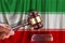 Judge wooden gavel on the background of the flag of iran. Oil and gas industry. The concept of oil fields and oil companies