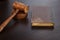 Judges Hammer or Gavel With Old Book On Dark Background