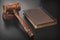 Judges Hammer or Gavel With Old Book On Dark Background