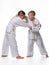 In a judo lesson, a boy and a girl fight and capture