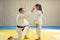 Judo master and young yellow belt judo girl