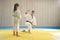 Judo master and young yellow belt judo girl