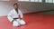 Judoka kneeling on the judo mat