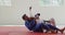 Judoka strangling his opponent on the judo mat