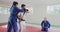 Judokas training while another is looking