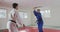 Judokas training with a wooden saber