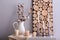 Jug with cotton branches and beautiful candles on table