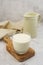 Jug and glass with milk on bright background isolated. Breakfast drink. Dairy