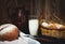 Jug and glass of milk on a wooden table basket with eggs and buckwheat bread